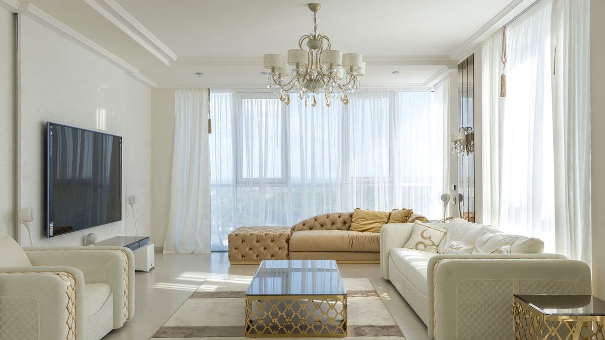 A bright, light-filled living room with clean windows in an apartment.